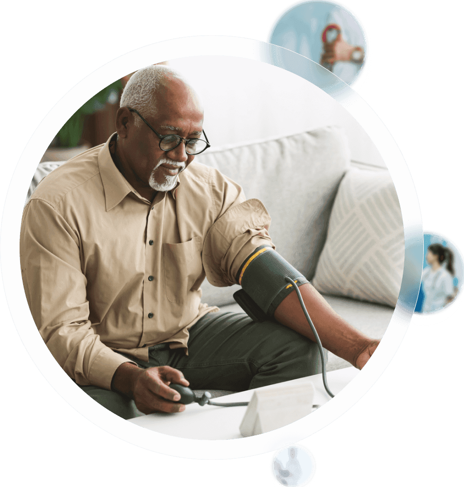 Clinical team collaborating during a GUIDE care coordination meeting, with one nurse standing at a laptop leading the discussion.