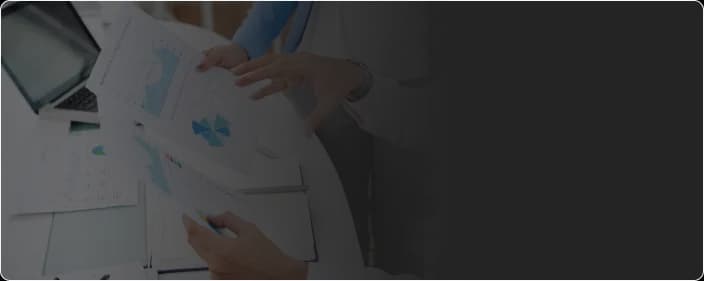 Computer and reports symbolizing simplified compliance and healthcare reporting with KangarooHealth.