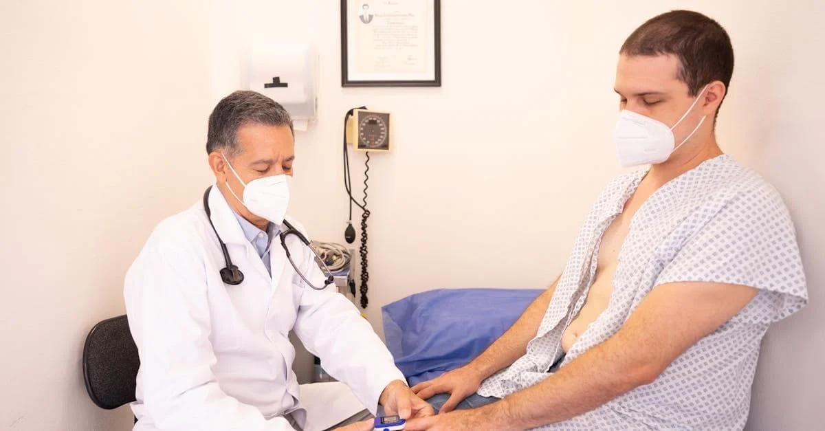 Doctor examining patient in hospital gown demonstrating cost containment healthcare strategies through efficient care.