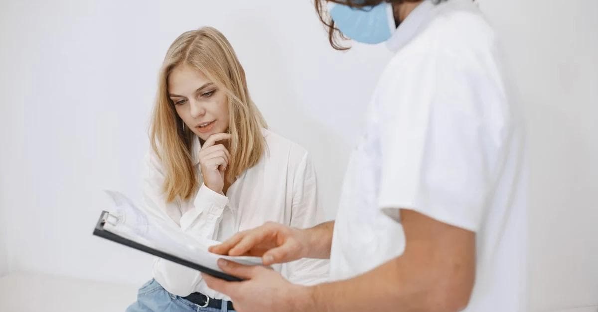 Healthcare provider reviewing Medicare Guide Program documentation with patient during consultation.