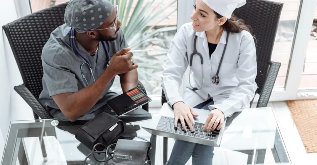 Doctor reviewing patient health data on laptop during medicare shared savings program consultation.