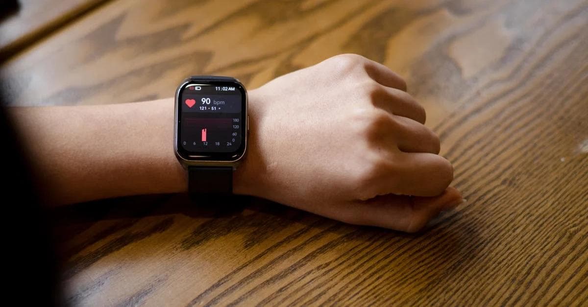 Smartwatch on wrist displaying heart rate data for remote patient monitoring heart failure management and cardiac health.