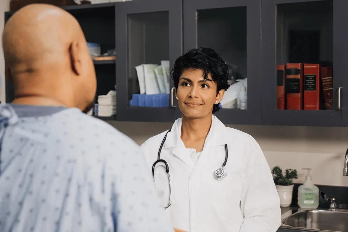 Female doctor attentively listening to patient in clinic.