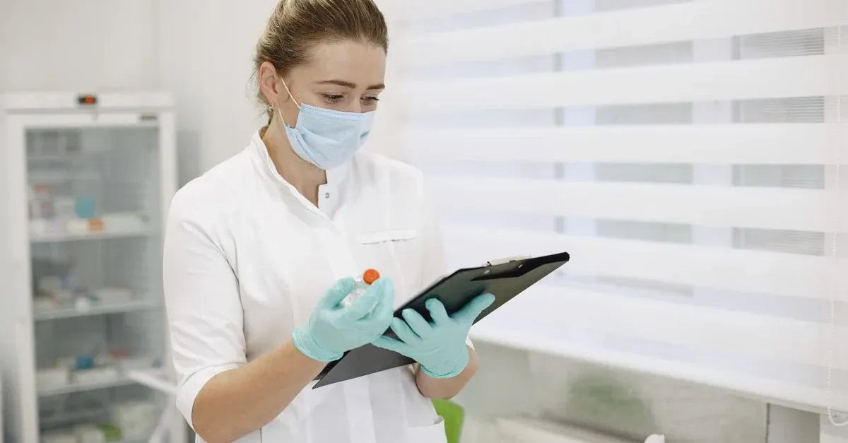 Healthcare professional reviewing digital tablet data in clinical setting to implement value based care.